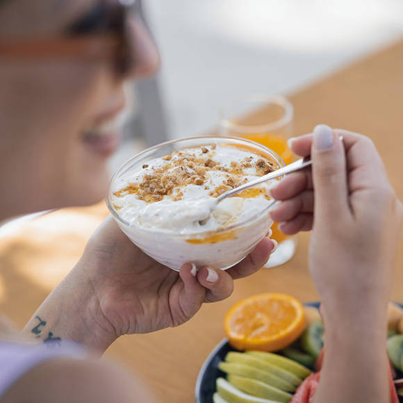 Close up of guest enjoying Greek yogurt with honey and fresh fruit at Avdou Collection Crete