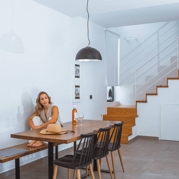 Bright villa interior with modern dining area, wooden stairs and relaxing atmosphere at Avdou Collection Crete