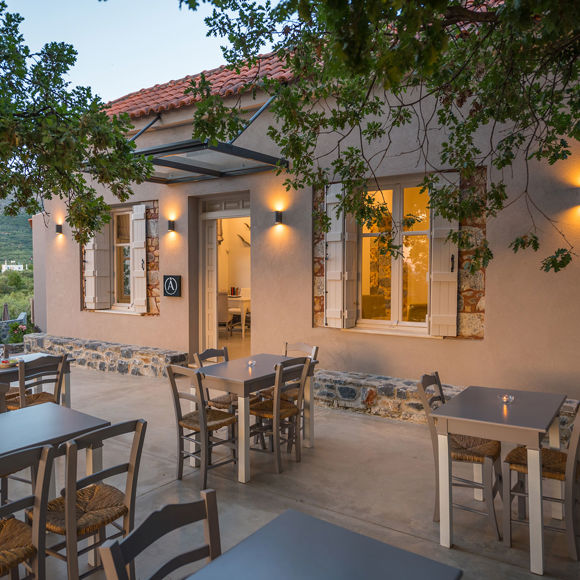 Cozy outdoor restaurant cafe with warm lighting and traditional seating at Avdou Collection Crete