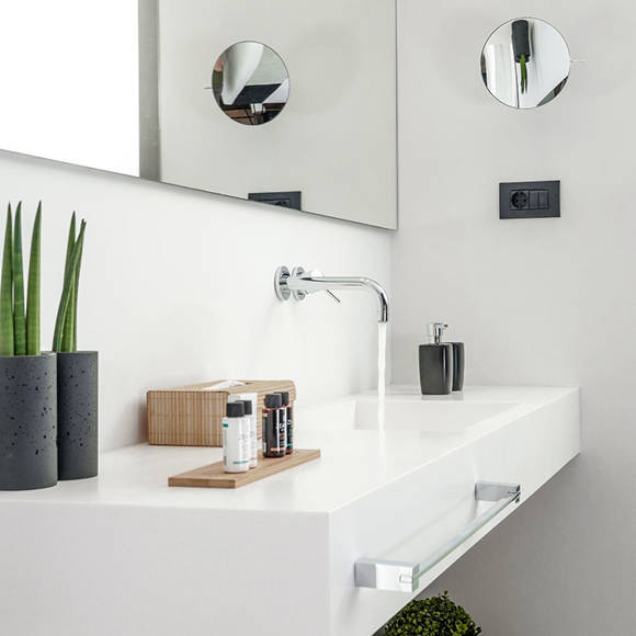 Grand villa bathroom with modern white sink, large mirror, toiletries and fresh towels at Avdou Collection Crete